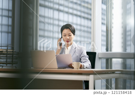 young asian business woman working in modern office 121158418