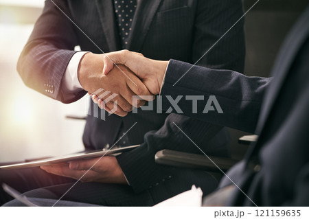 asian business people shaking hands in office 121159635