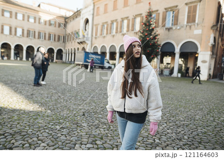 A Young Woman is Enjoying a Beautiful Winter Day in a Charming European Square Happily 121164603
