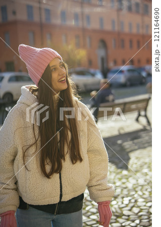 A Young Woman Relishing a Bright and Sunny Day While Relaxing in a Beautiful Park A Young Woman Relishing a Bright and Sunny Day While Relaxing in a Beautiful Park 121164690