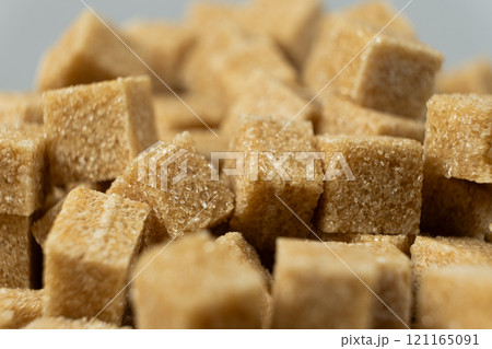 Macro cubes of brown cane unrefined demerara sugar. Macro cubes of brown cane unrefined demerara sugar. 121165091