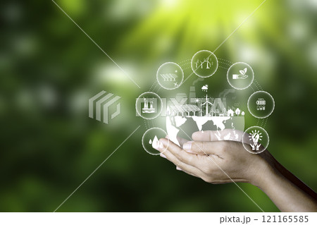 Net zero, carbon neutrality concept. Carbon Sequestration Icon at Hand and Green energy icon around it. Green Energy Renewable Sustainable. Net zero emission Idea innovative. 121165585