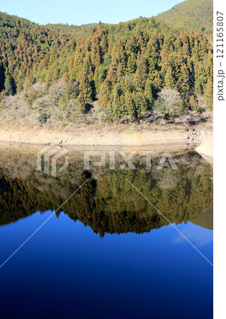 ダム湖に映る冬の青空 121165807