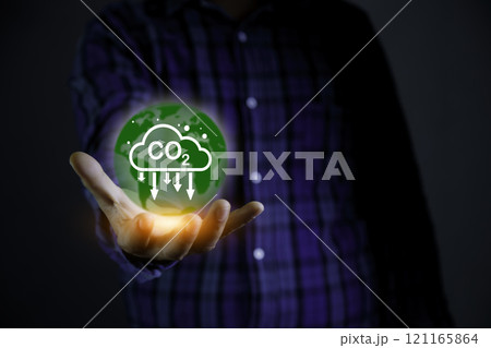 Green energy, Reduction of carbon emissions, carbon neutral concept. Carbon reduction sign on hand. Net zero greenhouse gas emissions target in 2050. Carbon dioxide emission in industry. 121165864
