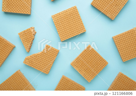 Square chocolate wafer biscuits on blue background. Square chocolate wafer biscuits on blue background. 121166806