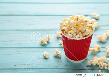 Delicious popcorn on light blue background. Space for text 121166830