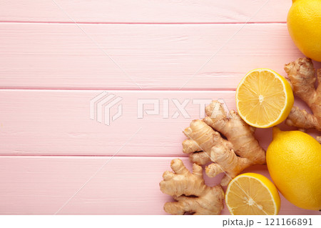 Lemon and ginger on pink background with copy space Lemon and ginger on pink background with copy space 121166891