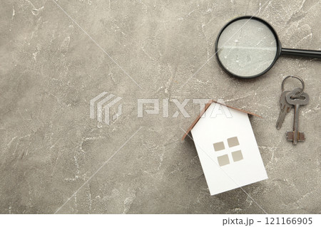 Paper house and key on grey background with copy space. Paper house and key on grey background with copy space. 121166905