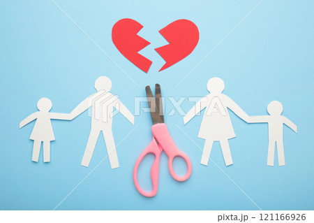 Scissors cutting paper cut of family on blue background. Broken family concept, divorce 121166926
