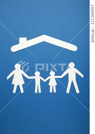 Happy paper family with roof on blue background with copy space. Family day. Vertical photo. 121166957