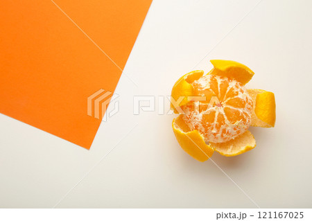 Fresh peeled mandarin orange on colorful background. Fresh peeled mandarin orange on colorful background. 121167025