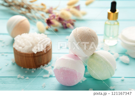 Aroma bath bombs in spa composition with dry flowers and salt on blue background. Vertical photo Aroma bath bombs in spa composition with dry flowers and salt on blue background. Vertical photo 121167347