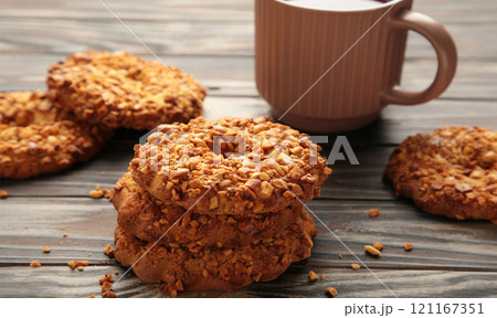 Peanut cookies with tea on brown background. Bakery products. 121167351