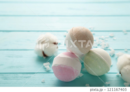 Aroma bath bombs in spa composition with dry flowers and salt on blue background. 121167403