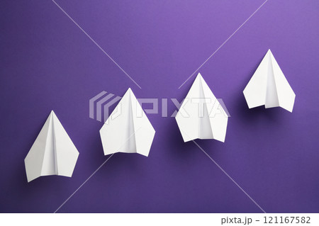 White paper plane on violet background, Business competition concept. 121167582