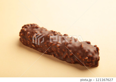 Chocolate bar on beige background. Sweety snack 121167627