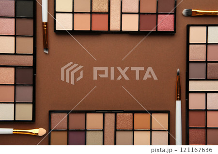 Professional makeup palette with brushes on brown background. Make up cosmetics 121167636