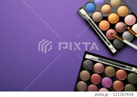 Professional makeup palette with brushes on purple background. Make up cosmetics 121167638