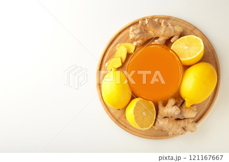 Ginger tea with lemon in a white cup on white background. 121167667