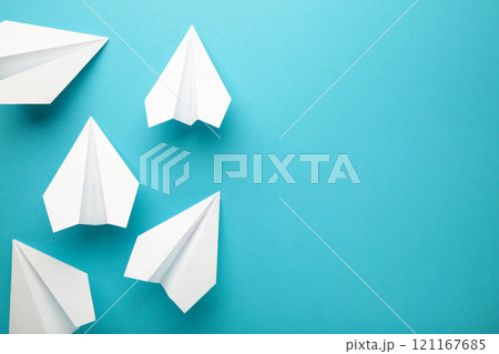 White paper airplanes on a blue background 121167685