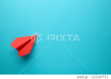 Red paper airplane on a blue background Red paper airplane on a blue background 121167711