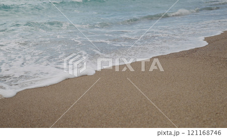 Clear blue waves with strong wind on a sandy empty beach in Cannes in spring 121168746