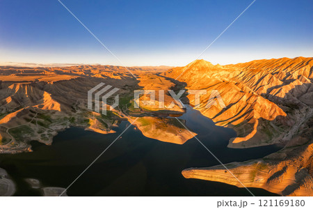 Panoramic aerial view on picturesque Azat reservoir and Eranos mountain at bright sunny evning sunset. Lake with blue water in arid area and Yeranos mountains range. Beautiful landscape. Armenia. 121169180