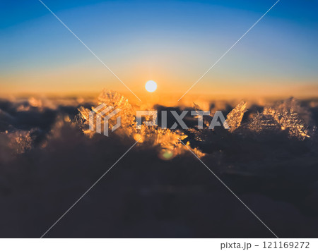 Frosty air and frozen lake surface in a beautiful sunset landscape. Beautiful ice shapes and sunlight. Photo from Sotkamo, Finland. Frosty air and frozen lake surface in a beautiful sunset landscape. Beautiful ice shapes and sunlight. Photo from Sotkamo, Finland. 121169272