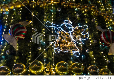 Christmas decorations on the Christmas tree. An angel singing on a trumpet 121170014