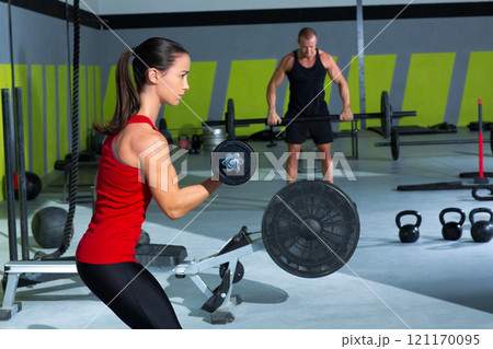 girl dumbbell and man weight lifting bar workout girl dumbbell and man weight lifting bar workout 121170095