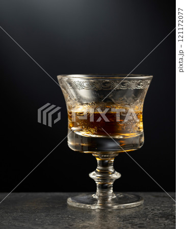 Brandy snifter on a black stone table. 121172077