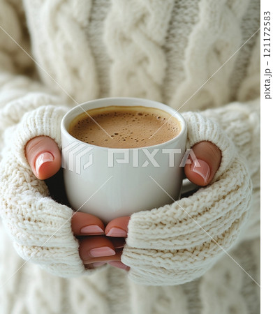 Enjoying a warm cup of coffee with winter mittens on a chilly day 121172583