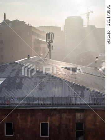 sun lit rooftops of city houses through smog sun lit rooftops of city houses through smog 121173931