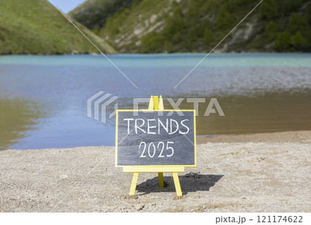 Planning trends 2025 new year symbol. Concept words Trends 2025 on beautiful yellow chalk blackboard. Beautiful mountain lake sand beach background. Business trends 2025 new year concept. Copy space. Planning trends 2025 new year symbol. Concept words Trends 2025 on beautiful yellow chalk blackboard. Beautiful mountain lake sand beach background. Business trends 2025 new year concept. Copy space. 121174622