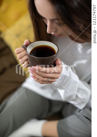 Enjoy a Cozy Morning Coffee Moment Surrounded by Warm and Inviting Tones of Comfort Enjoy a Cozy Morning Coffee Moment Surrounded by Warm and Inviting Tones of Comfort 121174797