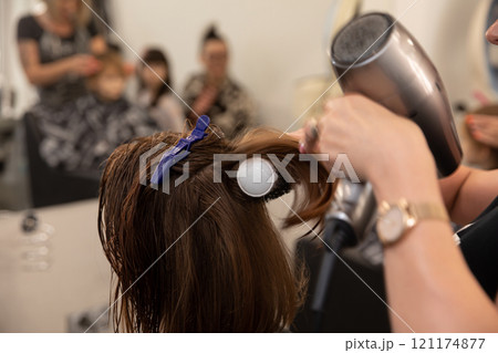 A Professional Hair Styling Session in Full Action, Showcasing Skill and Elegance 121174877