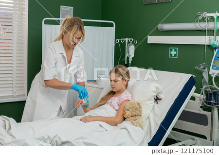 A nurse providing compassionate care and support for a patient located in a hospital room 121175100