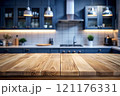Wooden countertop on a blurred background of a trendy, blue kitchen 121176331
