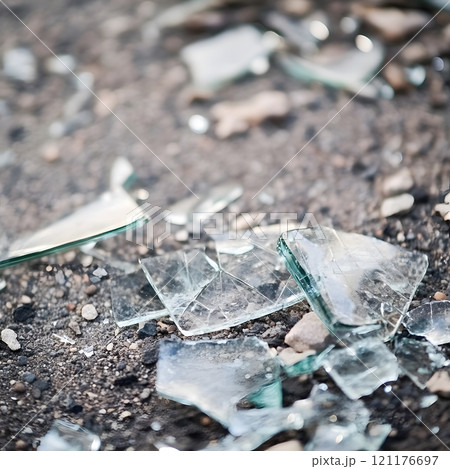 Shattered broken glass debris sharp trash on the ground	 121176697