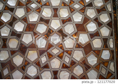 Islamic geometric pattern in wood and nacre. Background 121177020