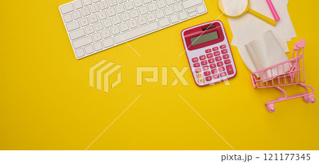 White wireless keyboard, stack of paper receipts and magnifier on yellow background, budget analysis concept, savings White wireless keyboard, stack of paper receipts and magnifier on yellow background, budget analysis concept, savings 121177345