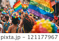 Crowd celebrating with rainbow flags at a public event 121177967