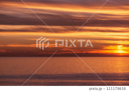 Amazing sunset sky above the sea surface. Amazing sunset sky above the sea surface. 121178638
