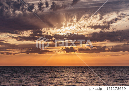 Amazing sunset sky above the sea surface. Amazing sunset sky above the sea surface. 121178639