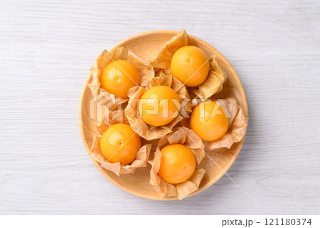 Cape gooseberry, Golden berry (Physalis peruviana) in wooden bowl on white background 121180374