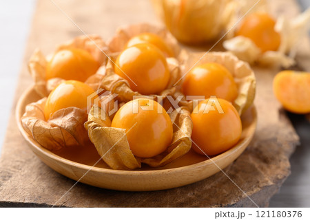 Cape gooseberry or Golden berry (Physalis peruviana) in wooden bowl, Healthy fruit Cape gooseberry or Golden berry (Physalis peruviana) in wooden bowl, Healthy fruit 121180376
