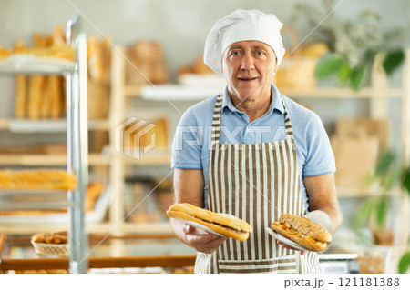 Elderly man seller with bocadillo in bakery Elderly man seller with bocadillo in bakery 121181388