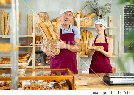 Elderly man and young woman sellers with baguettes and bocadillo Elderly man and young woman sellers with baguettes and bocadillo 121181538