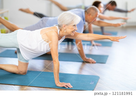 Elderly woman doing pilates in group Elderly woman doing pilates in group 121181991