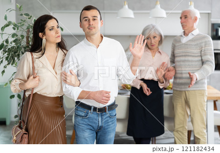 Disgruntled elderly parents accompany their son and daughter-in-law. 121182434